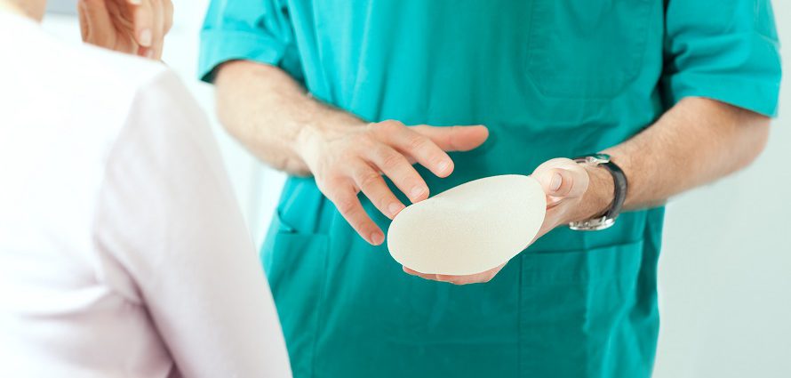 breast surgeon discusses implant options with patient