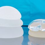 silicone and saline breast implants piled together