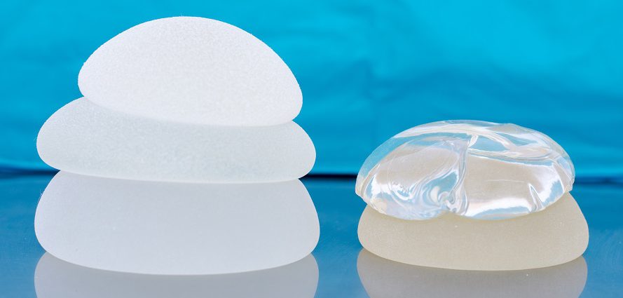 silicone and saline breast implants piled together