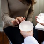 female patient choosing between breast implant types