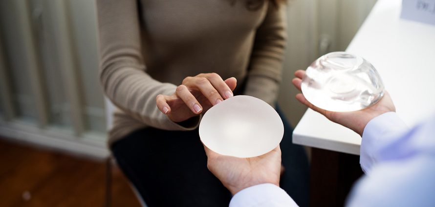 female patient choosing between breast implant types