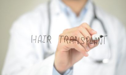 concept of a male doctor writing hair transplant on screen