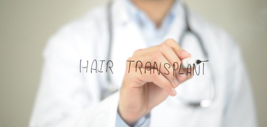 concept of a male doctor writing hair transplant on screen