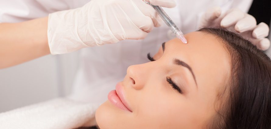 female patient receiving injection to forehead