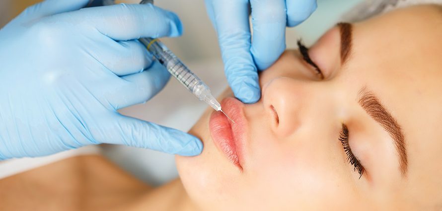 young female patient getting lip injections