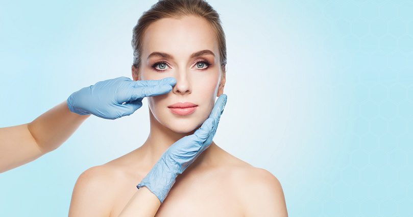 doctor evaluating the nose of a female patient at consult