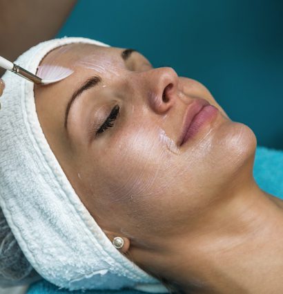 female patient receiving a chemical peel facial