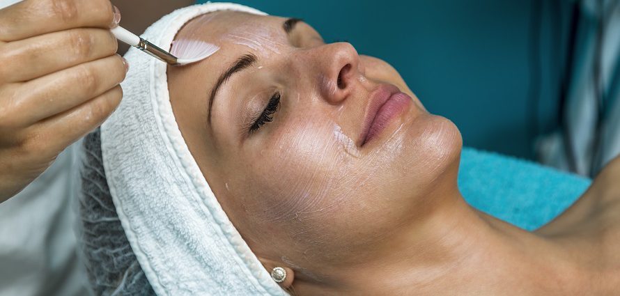 female patient receiving a chemical peel facial